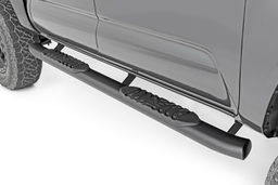 Oval Nerf Step Bars for Toyota Tacoma (2005-2023) shown installed, Rough Country 21008