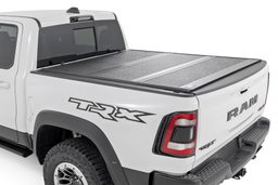 Hard Low Profile Tri-Fold Bed Cover for 2019-2025 Ram 1500 shown installed, Rough Country 47320650B